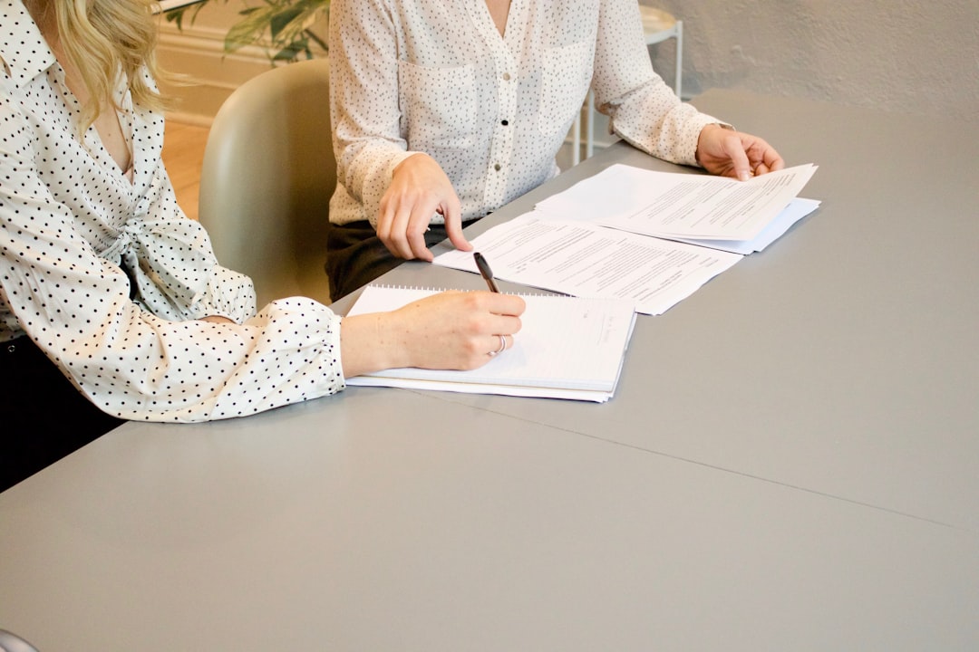 services-02 woman-signing-on-white-printer-paper-beside-woman-about-to-touch-the-documents-hjckknwcxxq