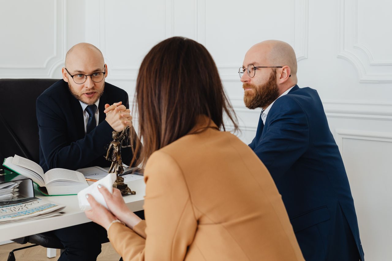 about-01 Professional discussion among lawyers in a modern office, focusing on legal matters.